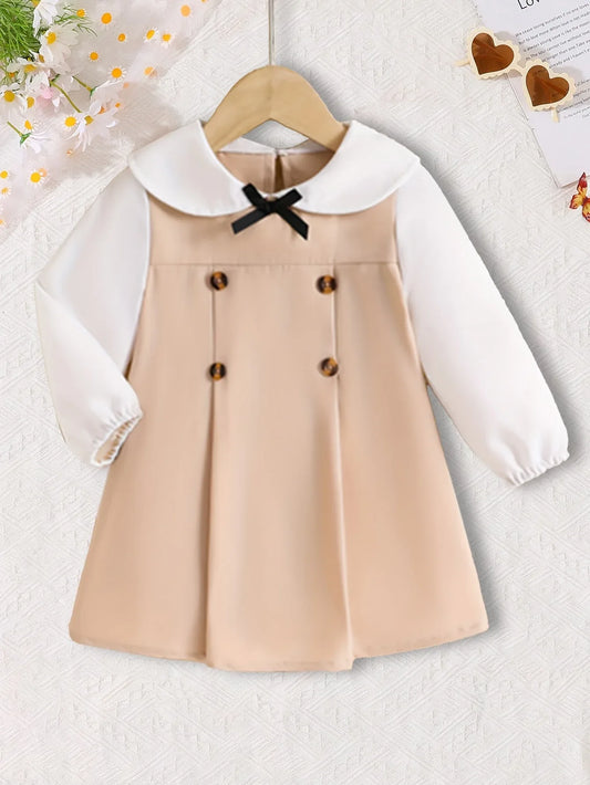 This Is a Stylish And Versatile Long-Sleeve Dress for Baby Girls, Featuring a Casual Yet Elegant Design with a Black Bow Button Decoration And a Color-Blocked Pattern, Perfect for Outings. - alotasawkli