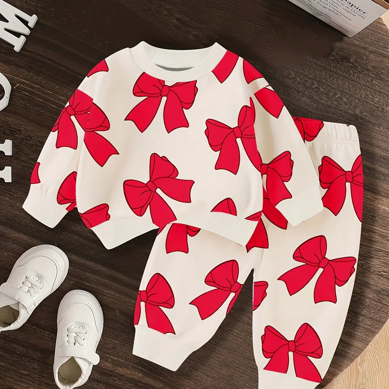 A Cute Cartoon Long-Sleeve Top with a Bow Pattern And Matching Long Pants Set for Baby Girls, Perfect for Outdoor Wear. - alotasawkli