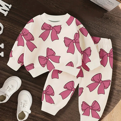 A Cute Cartoon Long-Sleeve Top with a Bow Pattern And Matching Long Pants Set for Baby Girls, Perfect for Outdoor Wear. - alotasawkli