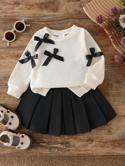 A Two-Piece Set for Baby Girls Featuring a Round-Neck Long-Sleeve T-Shirt Adorned with Multiple Black 3D Bow Decorations And a Solid Black Pleated Skirt, for Outdoor - alotasawkli