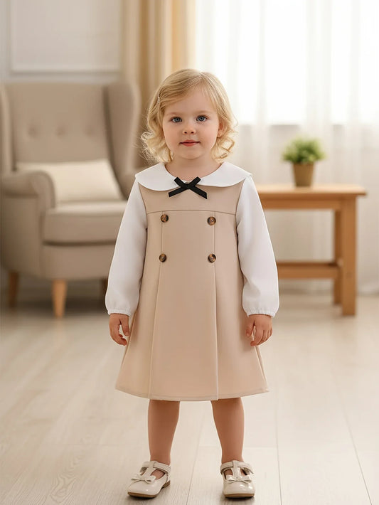 This Is a Stylish And Versatile Long-Sleeve Dress for Baby Girls, Featuring a Casual Yet Elegant Design with a Black Bow Button Decoration And a Color-Blocked Pattern, Perfect for Outings. - alotasawkli