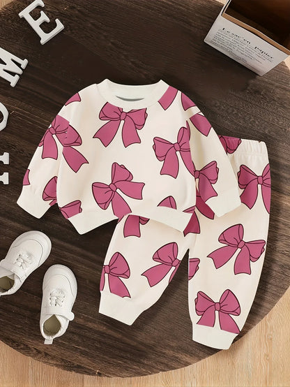 A Cute Cartoon Long-Sleeve Top with a Bow Pattern And Matching Long Pants Set for Baby Girls, Perfect for Outdoor Wear. - alotasawkli