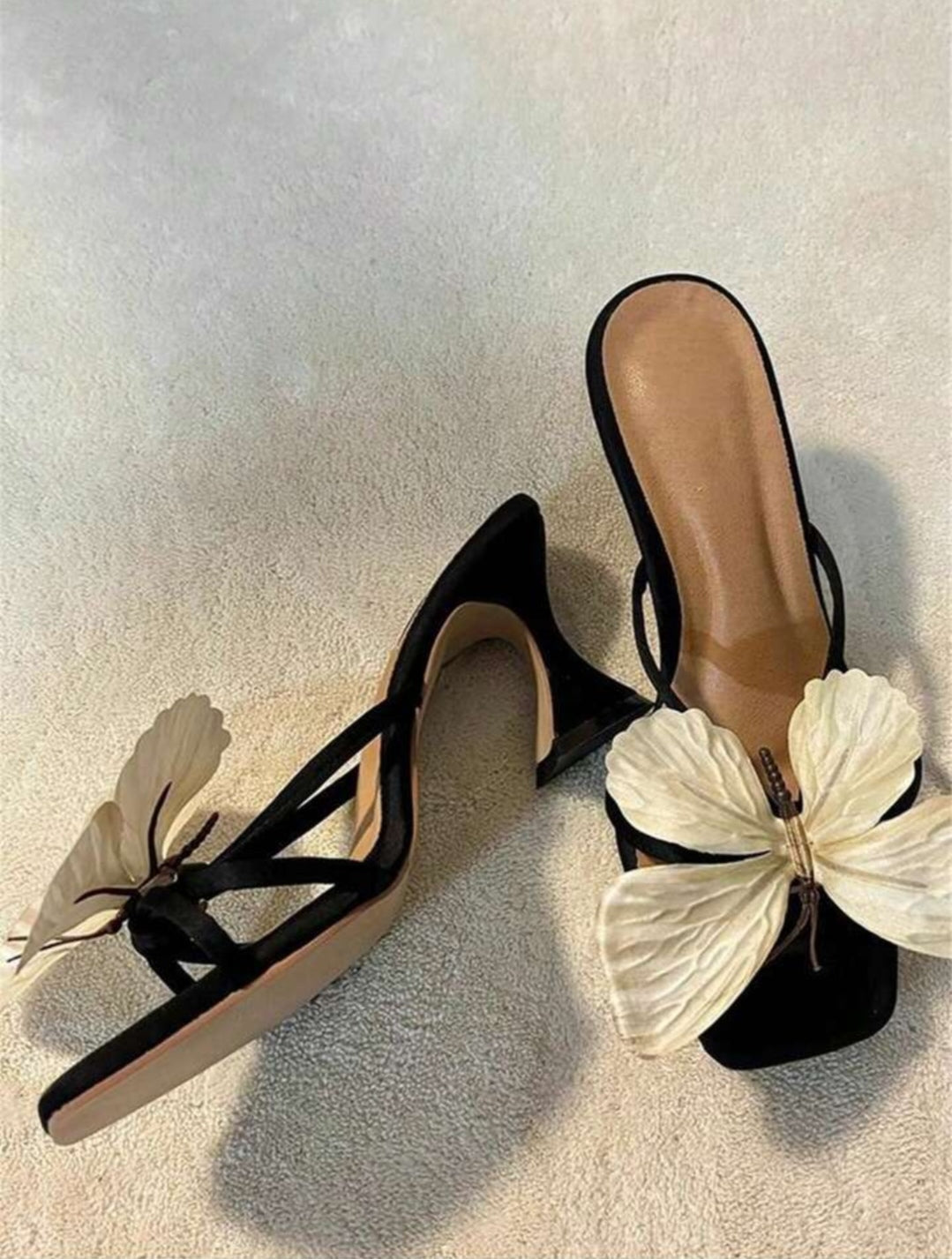 Elegant women's sandals featuring an ornate butterfly design