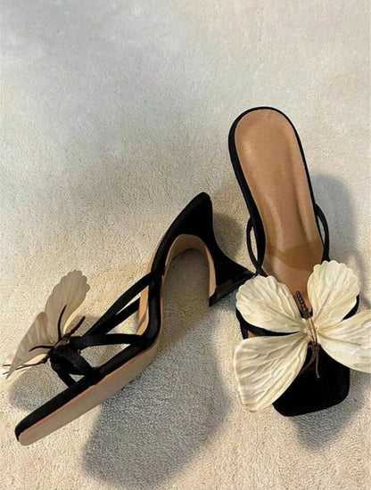 Elegant women's sandals featuring an ornate butterfly design