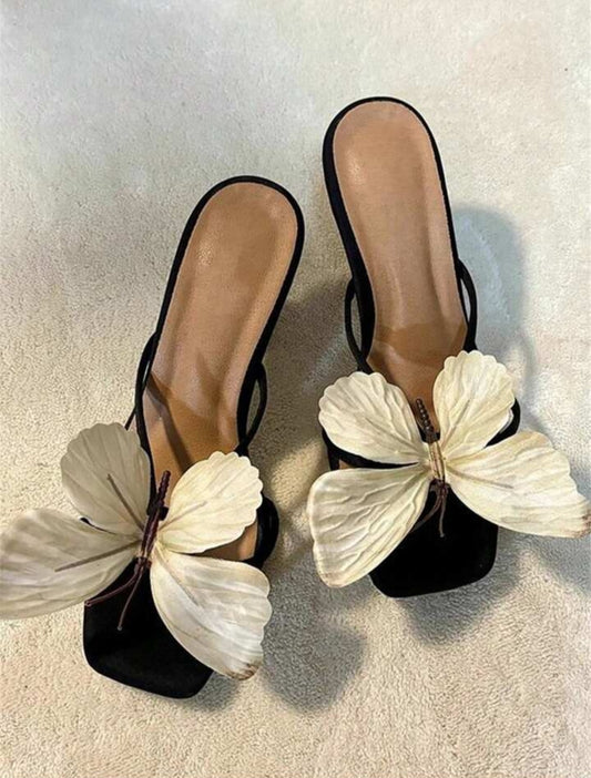 Elegant women's sandals featuring an ornate butterfly design